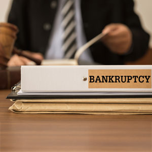 Lawyer reviews 'BANKRUPTCY' folder, with a gavel nearby, for 'Best of the Best Bankruptcy Lawyer'.