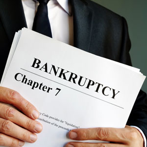 Notebook titled 'BANKRUPTCY CHAPTER 7' with charts for credit cards after filing.