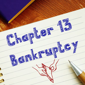 Notebook with 'Chapter 13 Bankruptcy' written, alongside a pen, ideal for West Virginia.