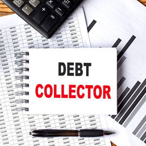 Notebook with 'DEBT COLLECTOR' on financials, and a calculator and pen.