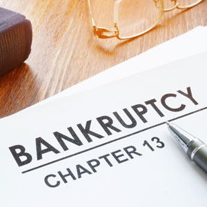 Chapter 13 bankruptcy document with pen and glasses, for income increase queries.