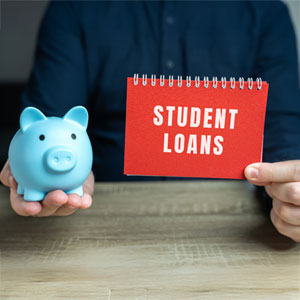 Man holding piggy bank and 'STUDENT LOANS' sign, for bankruptcy relief information.