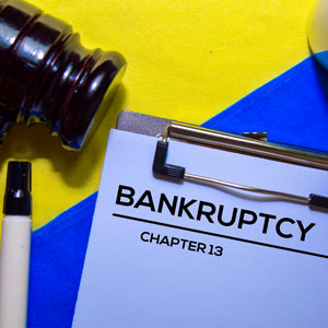 Bankruptcy Chapter 13 document on a clipboard, representing small business benefits.